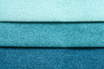 textile background in  form of horizontal stripes.  set of multi-colored dense fabrics of  uniform texture. choice of materials in different colors. blue shades