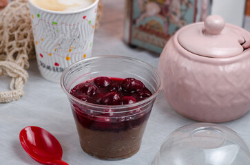 Chia seed dessert, chocolate pudding with cherries. Healthy breakfast. A plastic cup. Take and go food. Delivery.