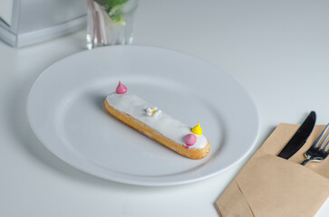 Traditional french eclairs filled with vanilla cream. Dessert in a cafe, restaurant or pastry shop.