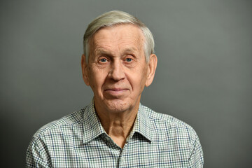 Studio portrait of smiling cheerful old man, 80 years old.