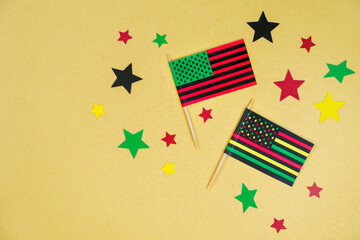 Black Liberation African American flags and stars on yellow background. Black History Month. 19th...