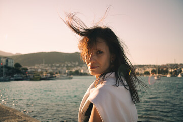 Woman on the street at sunset. Authentic and candid woman travel on road trip in european village