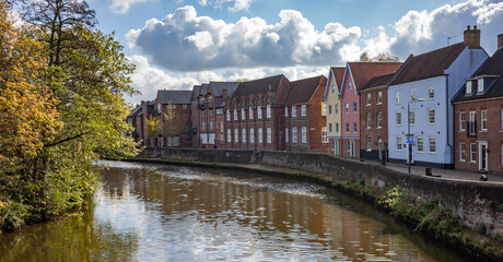 Fototapeta na wymiar Vibrant and colourful houses along the historic Quayside along the bank of the River Wensum