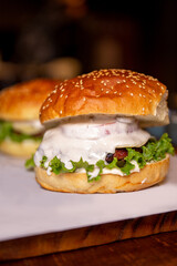 juicy burger with sauce and herbs close-up