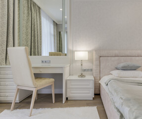 Fototapeta na wymiar Close-up bright bedroom with bed, large mirror and dressing table