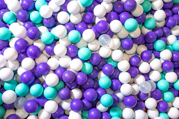beautiful background with colored plastic balls in the playroom pool. Pool for fun with white and blue balls