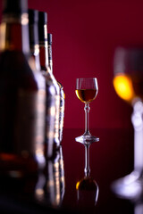 Two glasses of sparkling wine on the background of bottles