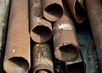 stacked rusty pipes, close-up as a texture for background