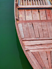 Detail of traditional wooden Vietnamese sampan rowboat on water