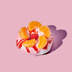 Decorated donut on pink pastel background