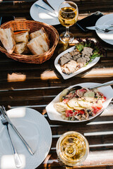 A table with sunshine with cutlery, food, wine for two people to celebrate. Concept of dining lunch. Business Lunch Concept. flat lay. top view.