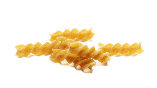 Pile wholemeal, integral pasta spirali isolated on white 