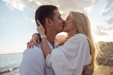 Close-up of happy couple kissing standing by the sea