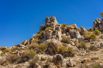 Low angel view of a hill with boulders and rocks in the Mojave Desert