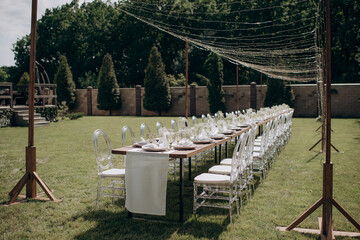 rectangular wedding festive set table in the patio, garden in nature