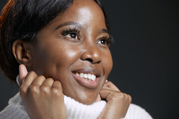 Smiling african american black woman looks up with hope, dreaming, feels happiness, inspiration. Closeup studio portrait