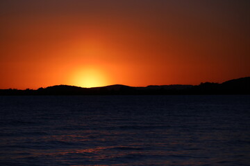 Cloudless  full sunset in the lake 
