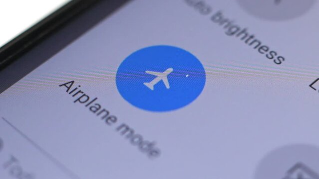 Macro close up of airplane mode button pressed on a LCD display
