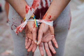  demonstration protest against rape and cruelty in Ukraine during the war. hands tied behind back,...