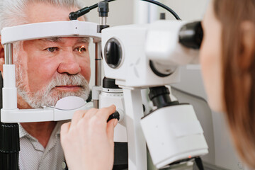 ophthalmologist examination of elderly man with slit lamp. medical equipment - obrazy, fototapety, plakaty