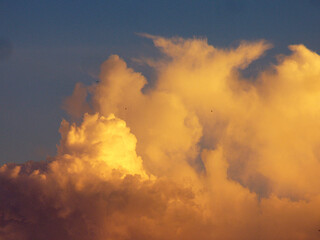 Fototapeta na wymiar yellow clouds in the blue sky