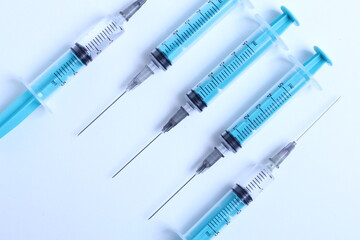 Medical syringe on a white background. A syringe for injection. The concept of health and beauty