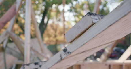 Construction worker walks up a wooden framework while wearing work boots