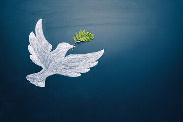 Dove of peace concept. Symbol of freedom and international day of peace. Chalk painted dove with olive branch - 501636737