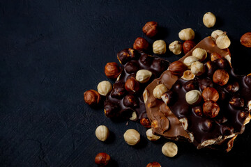 Top view in section on a bar of dark chocolate with hazelnuts