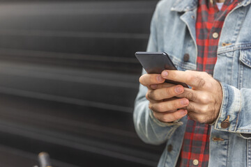Man using smart phone on street