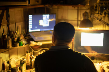 Hacker at computer. Man in dark.