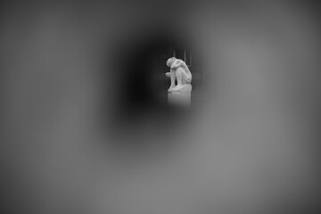Miniature sculpture. Peeping into hole.