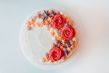 Homemade Classic Vanilla Marble Cream Cake Sprinkled with Creamy Flowers Decorations on a White Plate, Retro Rustic Color Decoration and Ornaments - obrazy, fototapety, plakaty