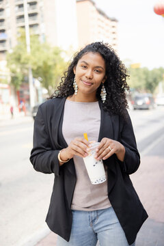 Portrait Smiling Young Woman Drinking Bubble Tea In City