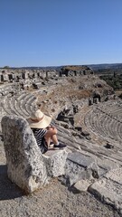 Miletus theater. The ancient roman amphitheater at Miletus, Turkey. The girl is sitting on a stone throne.