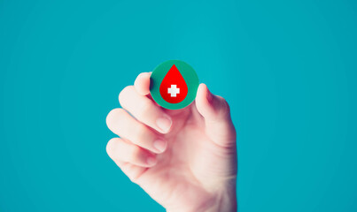blood donation, world blood donor day.Doctor holding red blood with white cross, health care, Marrow cancer, hemophilia anemia.world blood day, Leukemia, Thalassemia medical.hemophilia.Smear test.