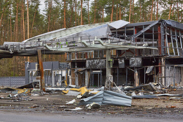 Fototapeta na wymiar Destroyed gas station as result of Russian attack on Ukraine. Gas station destroyed as result of missile attack on territory of Ukraine