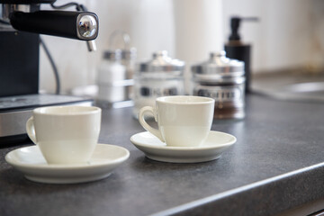 two cups of black coffee on the kitchen table