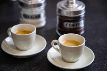two cups of black coffee on the kitchen table