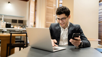 The manager is a man in glasses business suit working in the office, writes a message to the partner by e-mail