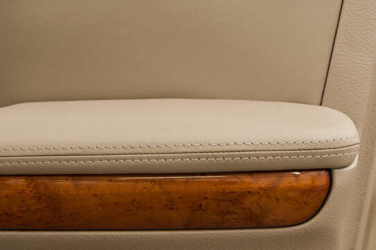 Leather background. Auto door armrest. Modern business car interior detail.