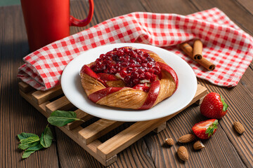 Fresh delicious puff pastry with sweet berries on dark wooden table, closeup