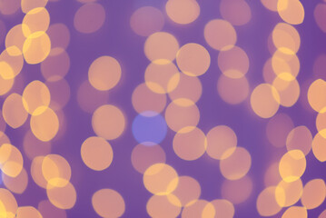 Blurred abstract: blurry orange circles in the purple background.