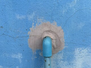 close up pvc pipe on blue wall