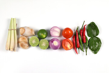 Tom Yum spiecs ingredients. Thai food, Thai soup on white background, lemongrass, galangal, lime, shallots, fresh chili, kaffir lime leaves, tomatoes, top view.