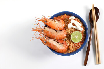 Instant noodles, Tom Yum Kung Flavor, Spicy Flavor Tom Yum Kung in a Blue Bowl on a white background, top view, copy space