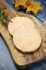 Slices of foie gras on wooden board