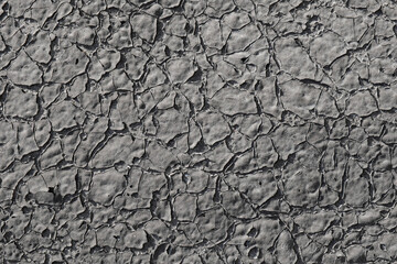 The texture of relief, gray, cracked from old age paint.