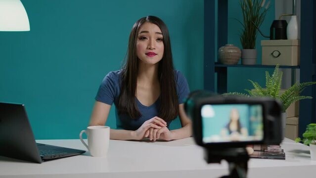 Content creator recording beauty videoblog with phone camera, doing makeup tutorial to give tips. Lifestyle blogger filming video on camera with streaming equipment and cosmetics.