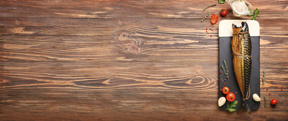 Board with tasty smoked mackerel fish on wooden background with space for text